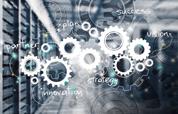 roues dentées représentant la notion de process, d'automatisation avec les mots innovation, stratégie et succès qui apparaissent sur l'image